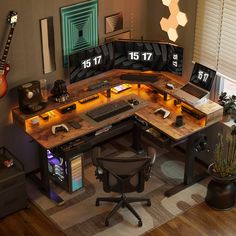 a computer desk with multiple monitors and keyboards on it, along with a guitar in the corner