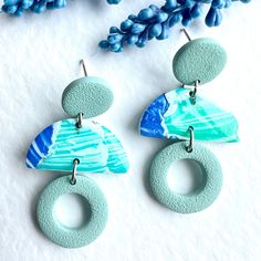 Add a pop of colour to your outfit with these stunning Blue and Turquoise Polymer Clay Earrings! These colourful dangle earrings are reminiscent of the tranquil ocean waters, making them the perfect "Something Blue" accessory. Handcrafted with care, these unique earrings are a thoughtful and vibrant gift for your best friend or a loved one. Stand out from the crowd with these striking earrings that are sure to make a stylish statement wherever you go!  They have  stainless steel post studs and f Modern Turquoise Dangle Earrings, Modern Turquoise Round Earrings, Blue Parfait, Ocean Earrings, Donut Shape, Blue Accessories, Earrings Polymer Clay, Steel Post, Best Friend Gift