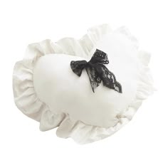 a white pillow with a black bow on the top and ruffles around it