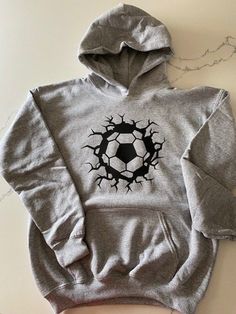 Soccer hoodie personalized. Custom soccer hoodie with name on the back or include team name. Great as a soccer team gift or gift for the coach!! Pullover hoodie with soccer ball design on front and name on the back. Different colors available. Contact Seller with custom requests. Sizing: S=6/6x, M=7/8, L=10/12, XL=14/16 Washing Instructions: 1. Turn garment inside out 2. Machine wash cold 3. No bleach 4. tumble dry on low 5. Do not iron Team Name Hoodie Fan Merchandise, Team Name Long Sleeve Hoodie For Fans, Fan Merchandise Hoodie With Team Name Long Sleeve, Team Name Fan Merchandise Hoodie, Team Spirit Fleece Hoodie With Long Sleeves, Fleece Team Spirit Hoodie, Team-colored Hooded Sweatshirt For Fans, Athletic Heather Fleece Hoodie With Letter Print, Fleece Hoodie For Sports Season