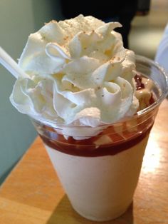 a cup filled with whipped cream and chocolate