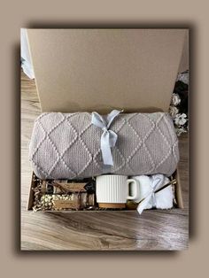 a coffee mug and blanket in a box