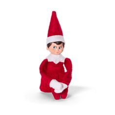 an elf doll sitting on the ground with his arms crossed and legs spread out, in front of a white background