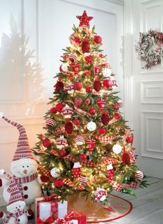 a decorated christmas tree with red and white ornaments