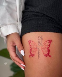 a woman's thigh with a butterfly tattoo on her left leg and the word love written in cursive writing