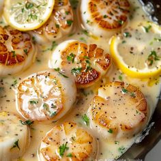 some scallops and lemons are cooking in a pan