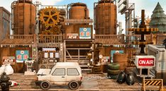 a car is parked in front of an industrial area with machinery and other things on the ground