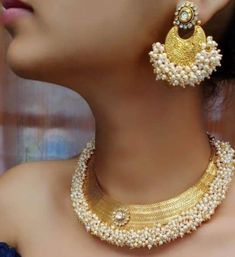 Very Gorgeous and elegant kundan Polki stone choker with pearl in antique gold with matching earrings and tikka Versatile. Can be paired with number of outfits. Perfect to wear at weddings occasions. Highest quality and craftsmanship Heavy Pearl Kundan Necklace Bollywood Style, Heavy Bollywood Kundan Necklace With Pearls, Heavy Chandbali Pearl Necklace For Diwali, Gold Chandbali Pearl Necklace With Heavy Detail, Heavy Gold Chandbali Pearl Necklace, Gold Chandbali Pearl Necklace For Reception, Gold Pearl Chandbali Necklace For Reception, Gold Kundan Temple Necklace With Pearl Drop, Heavy Gold Kundan Necklace With Pearls