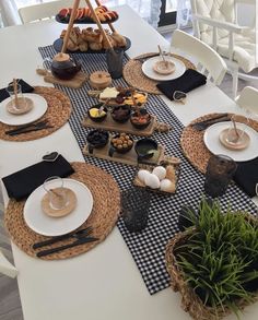 the table is set with black and white place settings