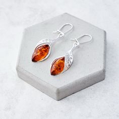 "Leaf Baltic amber and sterling silver statement earrings This lightweight pair of earrings is made of Baltic amber stones and perforated sterling silver (.925) elements. The earrings are 4.2cm (1.65\") long, 1.1cm (0.51\") wide with classic amber cabochons placed in a silver frame. Earrings are finished with French hooks. Check out this matching pendant: https://www.etsy.com/uk/listing/851861336/ Individually selected amber cabochons have been placed in exclusive, hand-crafted, hallmarked sterl Earring Christmas, Amber Bead Necklace, Vintage Gold Earrings, Silver Statement Earrings, Amber Earrings, Gold Statement Earrings, Statement Earring, Natural Amber, Earrings Elegant