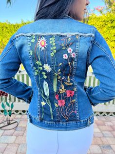 Ornate, stylish and comfortable blue or black denim jacket with overlay of intricate flowered lace design that is sewed strategically onto the jacket. Studs are applied to add style and brilliance. There is an option for rhinestone fringes.  And this is handmade, unique and one of a kind!  Express yourself with one of these fashionable jackets that will be custom designed for you!  Made with love and to bring out the beauty you have inside! Fitted Floral Print Denim Jacket, Bohemian Dark Wash Denim Jacket For Spring, Fitted Blue Denim Jacket With Floral Embroidery, Fitted Denim Jacket With Floral Embroidery, Fitted Denim Blue Outerwear With Floral Embroidery, Fitted Embroidered Dark Wash Denim Jacket, Fitted Denim Jacket With Floral Print, Fitted Denim Outerwear With Floral Embroidery, Fitted Embroidered Denim Blue Denim Jacket