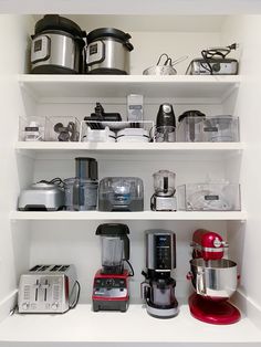 a kitchen shelf filled with appliances and other items