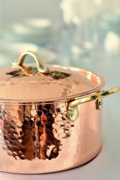 a large copper pot sitting on top of a table