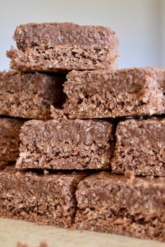 a stack of brownies sitting on top of a wooden table