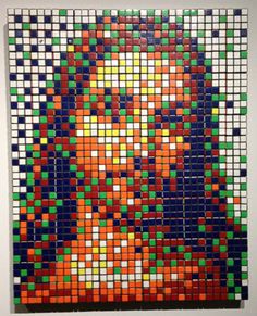 an art piece made out of legos and colored blocks on the side of a wall