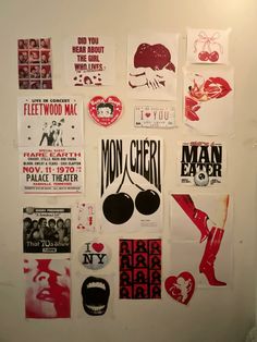 a wall covered in posters and stickers with different types of designs on them,