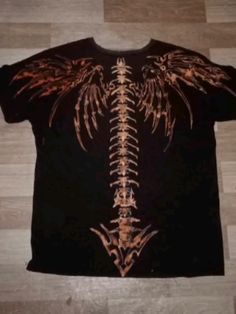 a t - shirt with an image of a skeleton and wings on it