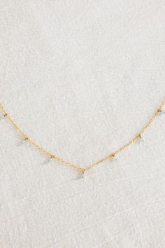 Dainty 14k gold filled plain chain necklace with seven dangling 3mm aquamarine stones (March birthstone) Please note: due to the uniqueness of each stone, the shape/colors may vary and will not look exactly like the photos If you would like a different length that is not listed, please consider purchasing an extender chain or contact us for a custom order! Delicate Chain Necklace For Anniversary, May Birthstone, Dainty Blue Aquamarine Jewelry, Aquamarine Birthstone Necklace, Gold Aquamarine Birthstone Necklace, Light Blue Aquamarine Gemstone Necklace, Swimwear Online, Jewelry Workshop, Aquamarine Stone, Jewelry Repair