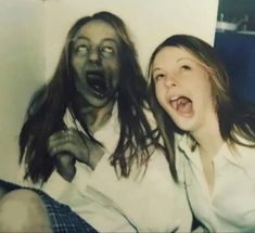 two people are posing for a photo with their mouths open and one person is screaming