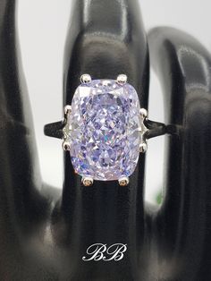 Made to order.  Please allow up to 3 weeks for the production of your ring. This listing is for a 925 non-plated sterling silver 8-prong solitaire ring with a 5A quality 14x10mm light purple colored crushed ice elongated cushion cut cubic zirconia stone. Gem Type: Lab Created Cubic Zirconia Shape: Crushed Ice Elongated Cushion Size: 14x10MM Weight: 8.5 Carat Approximately Color: Purple Quality: 5A Hardness: 8.5 Mohs Did you know there are different grades of cubic zirconia? (A - 6A) The higher the grade, the better the material, polish and more accurate the cut. Most cubic zirconia jewelry is made with grade 3A cubic zirconias. 3A (AAA) is a good and popular quality because of it's relatively cheap price. 3A stones are cut and polished faster so less care is taken during production. 6A qua Luxury Octagon Cubic Zirconia Ring, Gia Certified Purple Jewelry For Anniversary, Gia Certified Purple Jewelry For Anniversaries, Luxury Sterling Silver Octagon Ring, Luxury Octagon Sterling Silver Diamond Ring, Gia Certified Purple Diamond Jewelry, Dazzling Octagon Silver Rings, Silver Platinum Octagon Ring, Silver Octagon Moissanite Rings