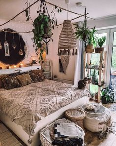 a large bed in a room with lots of plants on the headboard and foot board