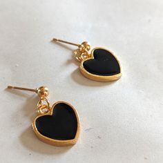 Dangling Black Hearts Gold Plated/Alloy Black Heart Charm Earrings As Gift, Black Earrings With Heart Charm For Gift, Black Heart-shaped Earrings For Gift, Trendy Black Heart-shaped Earrings, Black Heart Charm Earrings For Valentine's Day, Black Heart Earrings For Gift, Black Heart Charm Earrings For Gift, Black Heart Earrings With Heart Charm For Gift, Trendy Black Heart Earrings For Gift