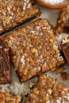 several pieces of brownie with nuts and coconut in the middle on top of rice