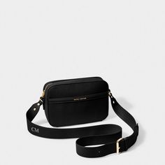 The ultimate wear-everywhere bag, the Cleo Crossbody Bag in Warm Black is designed to cater to multiple occasions. Inspired by the classic boxy camera bag profile, the Cleo Crossbody takes the classic components of a camera bag but puts a modern spin on it with the introduction of a front slip pocket for your essentials, an adjustable and detachable crossbody strap, and a PU trim detail. Paired with the iconic Katie Loxton features - vegan leather material and gold-tone hardware - this crossbody Classic Crossbody Camera Bag With Detachable Strap, Classic Camera Bag With Adjustable Strap For On-the-go, Classic Camera Bag With Removable Pouch For Travel, Classic Travel Camera Bag With Removable Pouch, Elegant Travel Camera Bag With Adjustable Strap, Classic Camera Shoulder Bag With Removable Pouch, Classic Shoulder Camera Bag With Removable Pouch, Classic Black Crossbody Camera Bag, Classic Crossbody Camera Bag For Travel