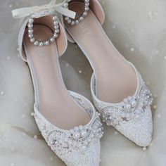 the bride's shoes are adorned with pearls