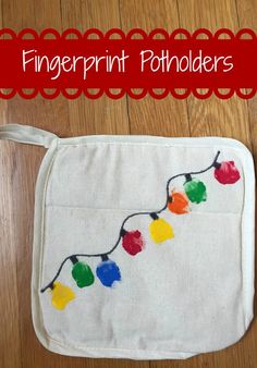 a white bag with christmas lights on it and the words fingerprint potholders written in red