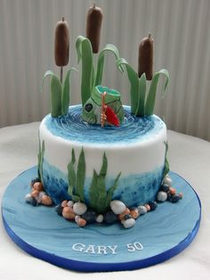 a cake decorated with an image of a fish in the water and plants on top