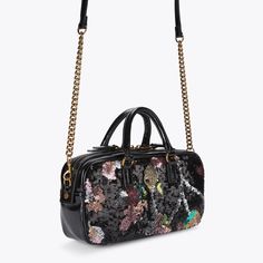 This Small Kensington Duffle Purse features a black exterior with sequin floral pattern across the front and back. There is an antiqued brass eagle head with crystals sat on the front5.9in (H), 10.6in (L), 2.7in (D)Strap length: 59.1inTwo top handlesFour antiqued brass feetAntiqued brass branded plate on the backInterior slip pocketCan fit phones up to 7inchesMaterial: LeatherStyle number: 3580909779 Black Embellished Top Handle Bag, Luxury Black Sequined Bags, Formal Black Bag With Sequins, Black Sequined Bags For Formal Occasions, Formal Black Sequin Bag, Knee Boots Flat, Micro Bags, Icon Shoes, Swimming Bag