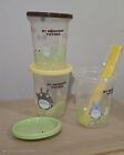 the blender is next to two plastic cups and a yellow cup with a straw in it