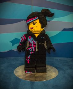 a lego figure made to look like a person wearing a black jacket and pink hat