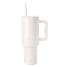 a white cup with a straw sticking out of it's side, on a white background