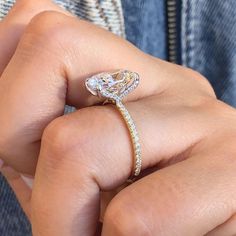 a woman's hand with a diamond ring on it