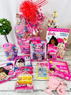 the contents of a barbie doll's birthday party are laid out on a table