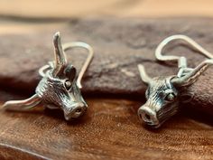 "This listing is for a pair of hypoallergenic sterling silver highland cow dangle earrings. A wee highland cow , or \"heilan'coo\" ... in sterling silver, as a pair of earrings! Also available as a pendant or jewellery set! Cast and hand finished in Sterling Silver with Sterling silver ear hooks .  *A high quality, unique product *Sold as PAIR  *Ethically traded sterling silver  *Pair Weight 4.6 gr *Gift boxed *Matching pendant and set with discount also available *Ships direct from Edinburgh, Scotland *Supports a small artisan business 'Highland Cattle' or 'Heilan Coo' (Scots) comes from the Gaelic translation of 'Ghaidhealach'. They are thought to have grazed on Scotland's rugged terrain since the sixth century, the Highland Cow has certainly seen Scotland through a lot of it's history. Cow Jewelry, Funny Necklace, Surviving In The Wild, Scottish Jewellery, Silver Gift Box, Cows Funny, Edinburgh Scotland, Jewellery Set, Scottish Highlands