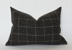 a black and white checkered pillow sitting on top of a table