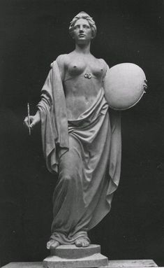 a statue with a ball in it's hand and an object on the other side