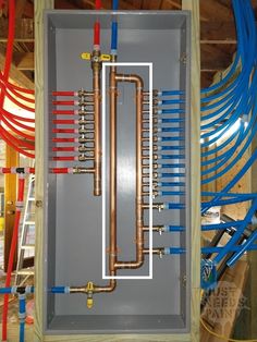 an electrical panel with several different types of pipes and wires attached to the back of it