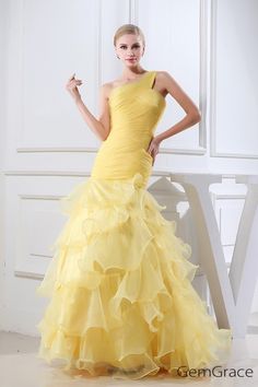 a woman in a yellow dress posing for the camera