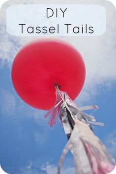 a red balloon floating in the air with text over it that reads diy tassel tails