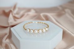 Five Fresh Water Pearls with Gold Filled Wiring showcases a refined piece of jewelry, where five lustrous pearls are meticulously chosen for their quality and seamlessly interconnected with elegant gold-filled wiring. This exquisite arrangement brings forth a harmonious blend of classic charm and modern finesse, making it a perfect accessory for various occasions. 14k Gold-filled Pearl Bracelet, Elegant Handmade 14k Gold-filled Pearl Bracelet, Fresh Water Pearl Ring, Elegant 14k Gold-filled Pearl Necklace, Thick Gold Hoops, Elegant 14k Gold-filled Pearl Necklace With Charm, Blue Stone Necklace, Pink Water, Fresh Water Pearls