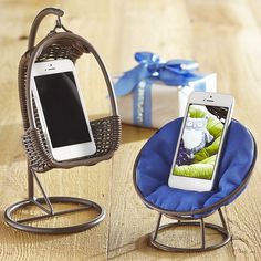 a cell phone sitting on top of a blue chair next to a gift wrapped present