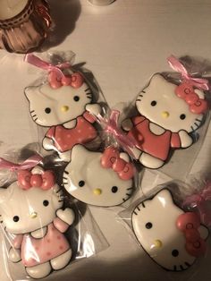 hello kitty cookies are wrapped in cellophane and have pink bows on their heads