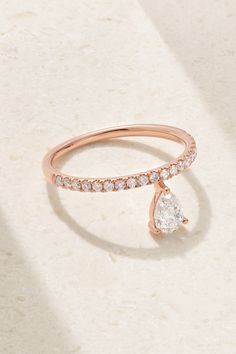 a rose gold ring with a pear shaped diamond