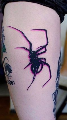 a woman's leg with a spider tattoo on the side of her thigh and an eye