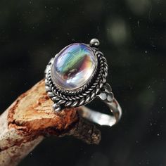 Stand out from the crowd with our boho chic iridescent mystic opal sterling silver ring. Our Little Luna is a beautiful ring with delicate detailing featuring an enchanting witchy mystic stone centre. A Shop Dixi classic to enhance your bohemian jewellery collection. MaterialSterling SilverSynthetic Mystic Opal SizingRing Front - Height 18mm Magical Adjustable Silver Crystal Ring, Ethereal Silver Crystal Ring Gift, Silver Ethereal Crystal Ring Gift, Handmade Magical Silver Crystal Ring, Ethereal Silver Crystal Ring For Gift, Silver Crystal Ring For Gift In Ethereal Style, Adjustable Silver Magical Style Rings, Mystical Handmade Iridescent Ring, Mystical Crystal Gemstone Ring