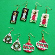 six pairs of beaded christmas ornament earrings on a green surface with gold - plated earwires